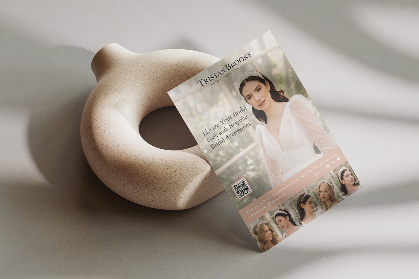 Bridal accessories flyer design propped against a ceramic sculpture.