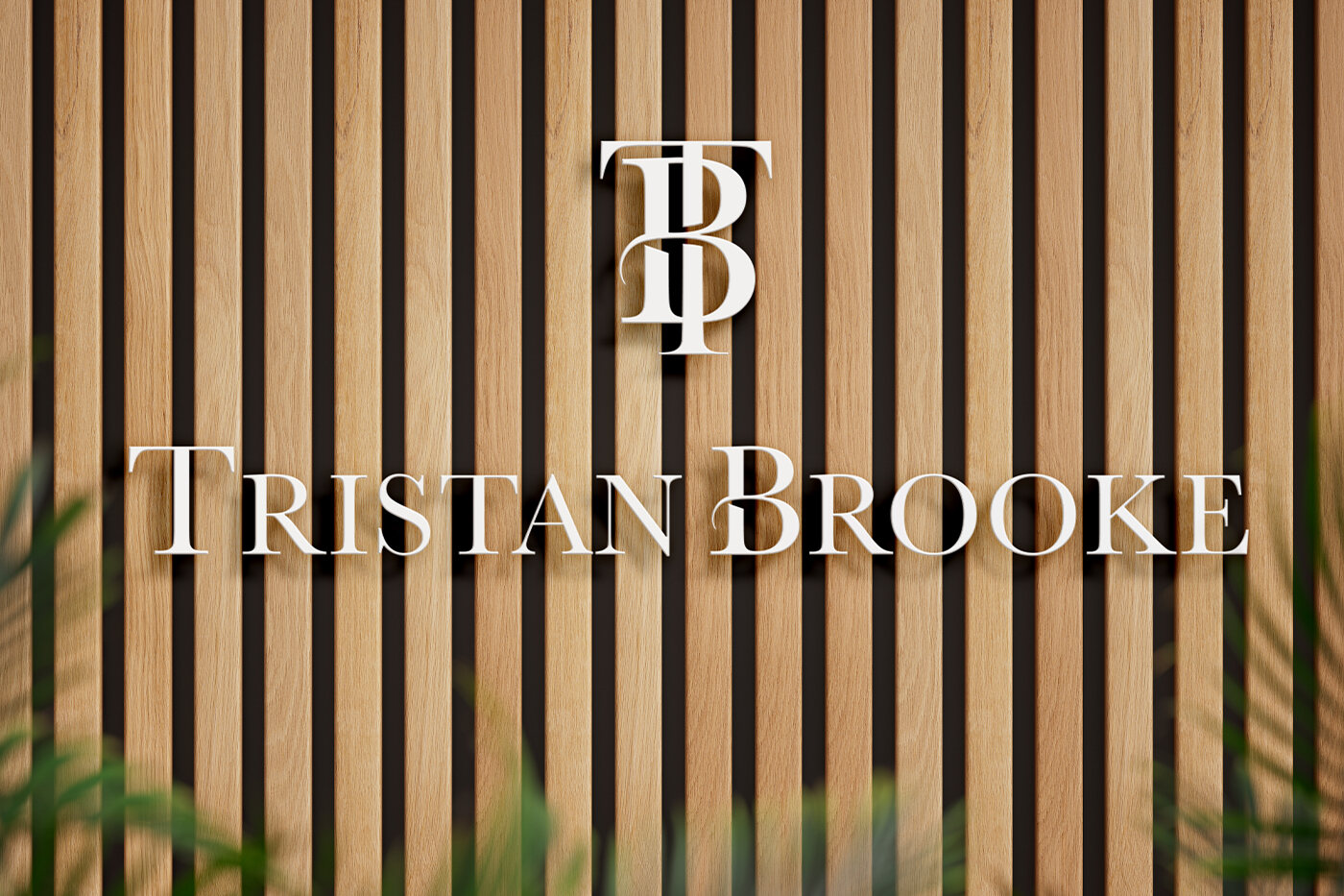Monogram and wordmark signage mounted on a slatted wood wall.